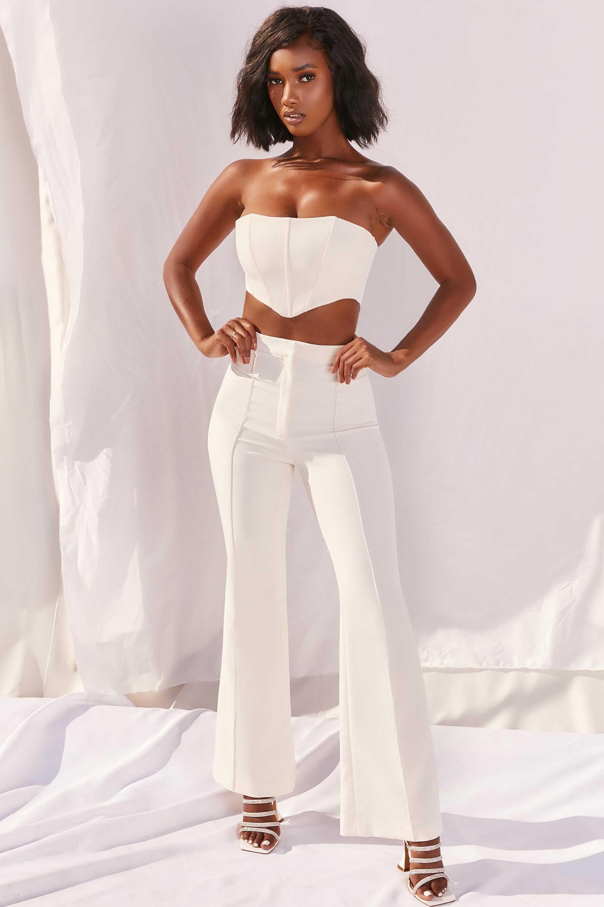 Bossin’ Up Petite High Waisted Tailored Flare Leg Trousers in Ivory sold by Oh Polly