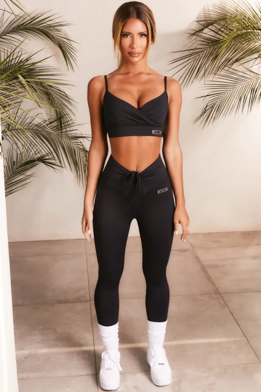 Resistance Slinky Wrap Front Sports Bra in Black sold by Oh Polly