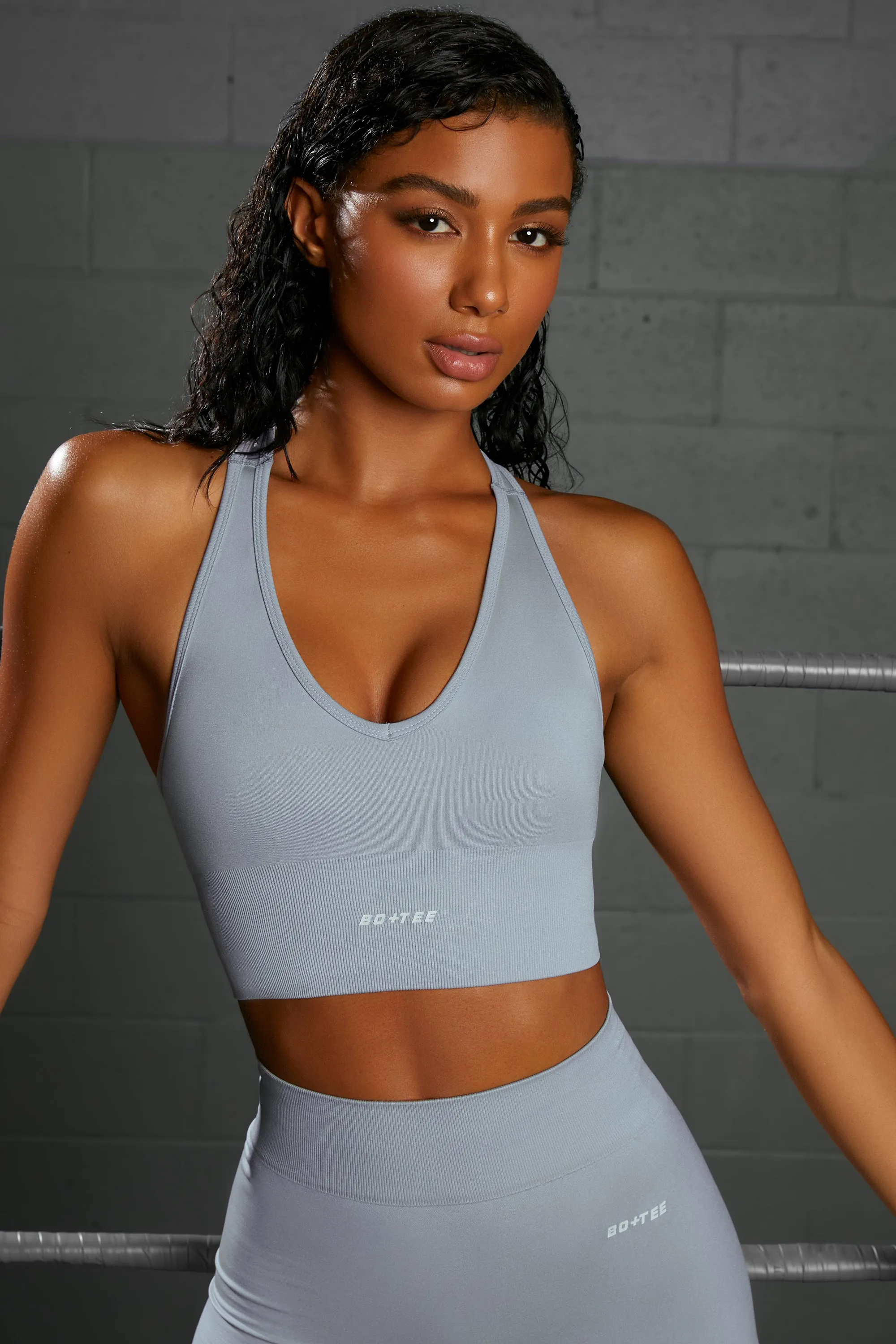 Overhaul Racer Knot Back Seamless Crop Top in Blue sold by Oh Polly