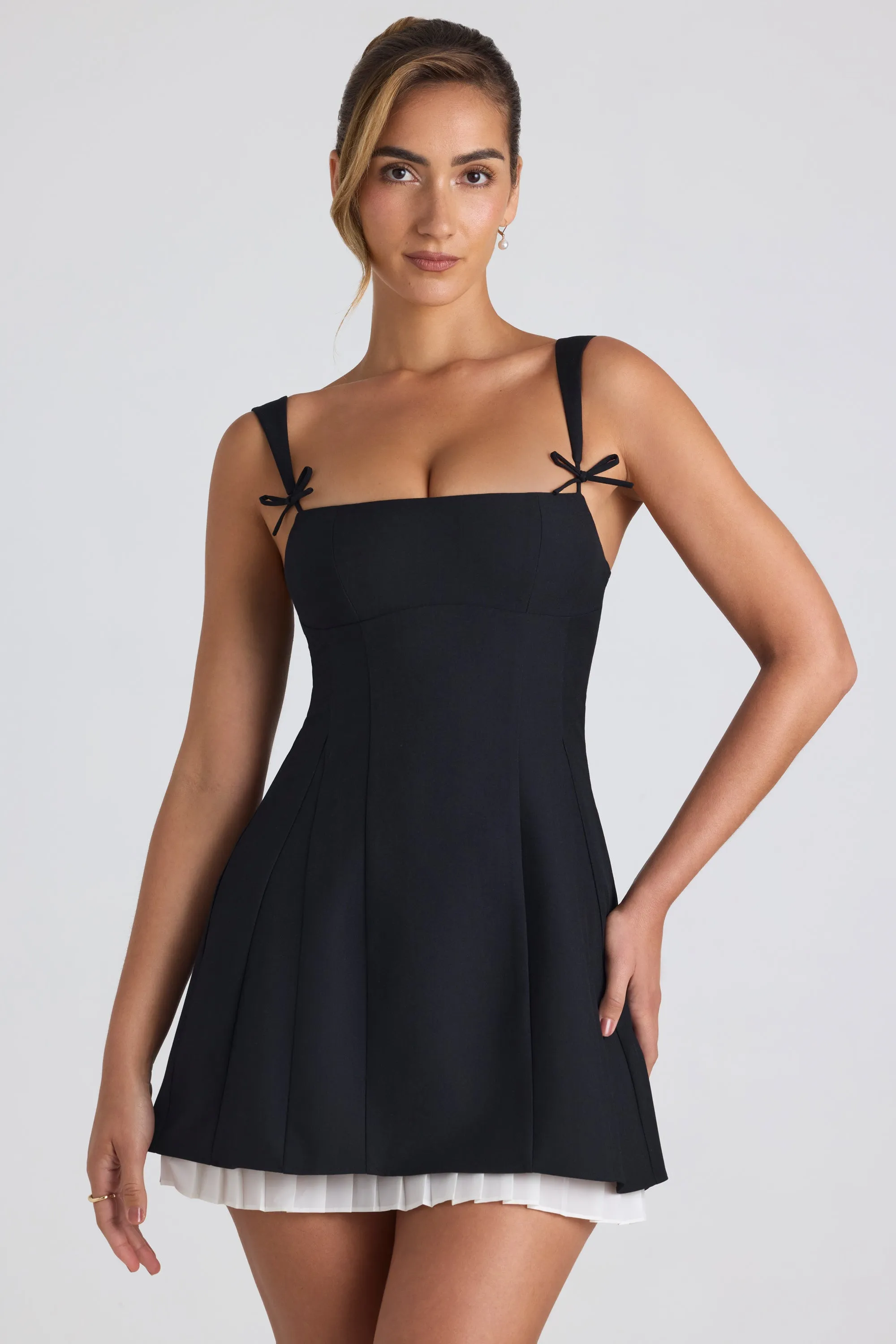 Bow-Detail Pleated A-Line Mini Dress in Black sold by Oh Polly