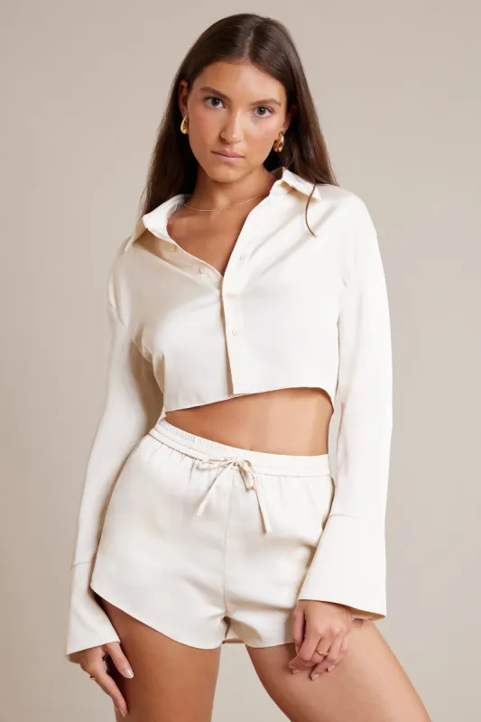 Bias Cut Satin Long Sleeve Cropped Shirt in Ivory sold by Oh Polly