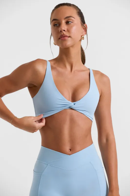 Twist Bust Sports Bra in Ice Blue sold by Oh Polly