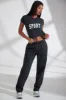Petite Wide Leg Embroidered Back Joggers in Black sold by Oh Polly
