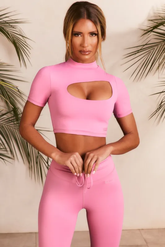 Power Up Slinky Cut Out High Neck Crop Top in Pink sold by Oh Polly
