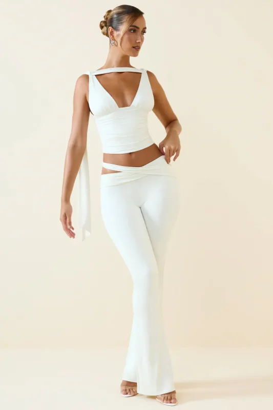 Tall Cut-Out Mid-Rise Flared Trousers in Vanilla sold by Oh Polly
