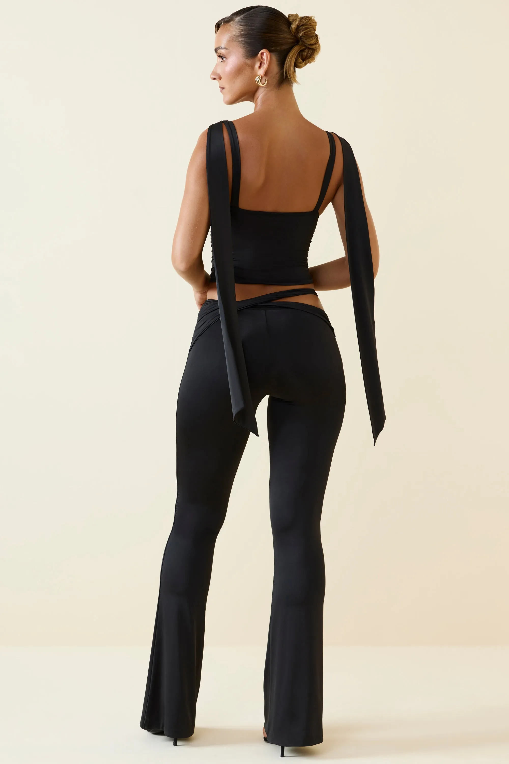 Tall Cut-Out Mid-Rise Flared Trousers in Black sold by Oh Polly product image thumbnail 2