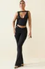 Petite Cut-Out Mid-Rise Flared Trousers in Black sold by Oh Polly