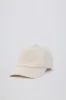 Baseball Cap in Washed Cream sold by Oh Polly