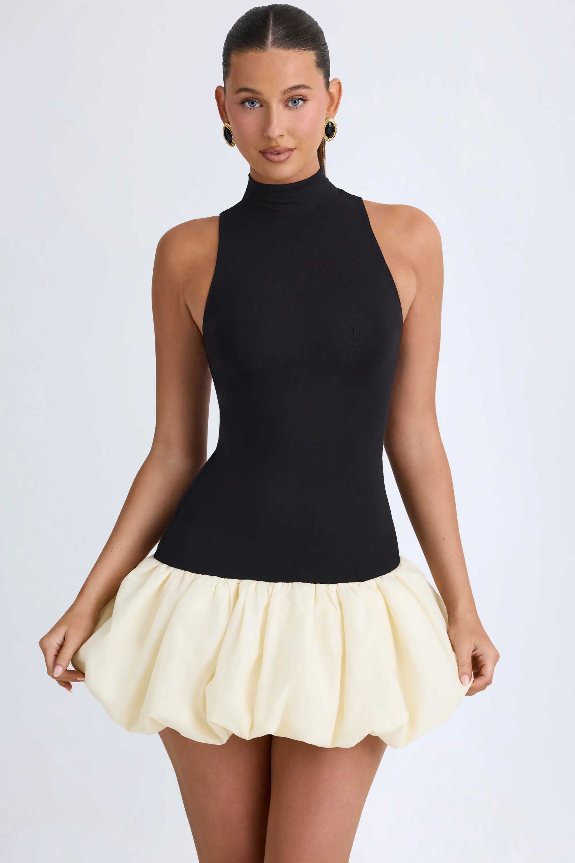 Turtleneck Drop-Waist Bubble Hem Mini Dress in Black sold by Oh Polly