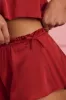 Mid-Rise Flared Shorts in Ruby Red sold by Oh Polly
