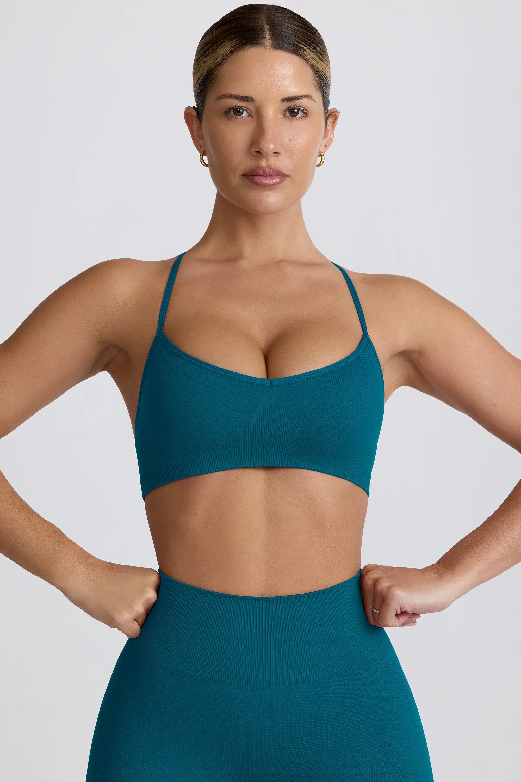 Super Sculpt Seamless Cross-Back Sports Bra in Teal sold by Oh Polly
