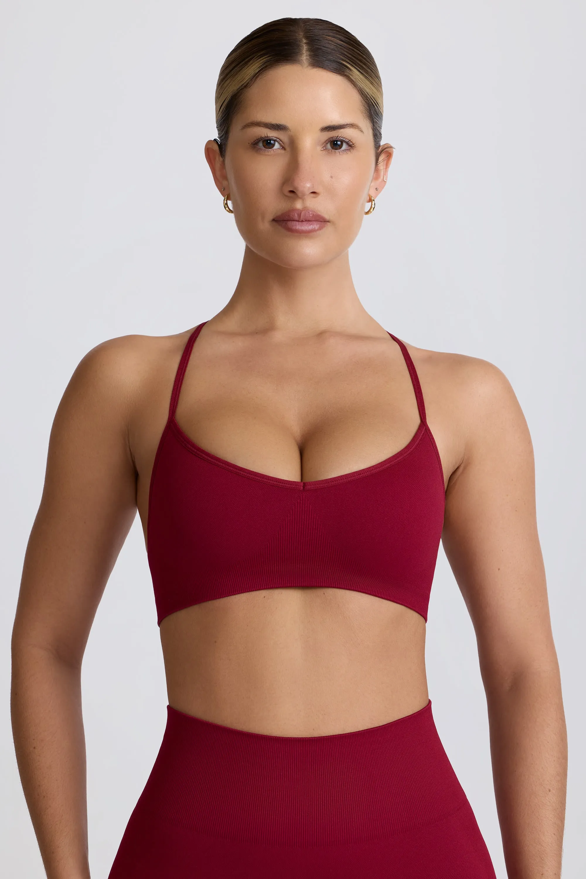 Super Sculpt Seamless Cross-Back Sports Bra in Burgundy sold by Oh Polly