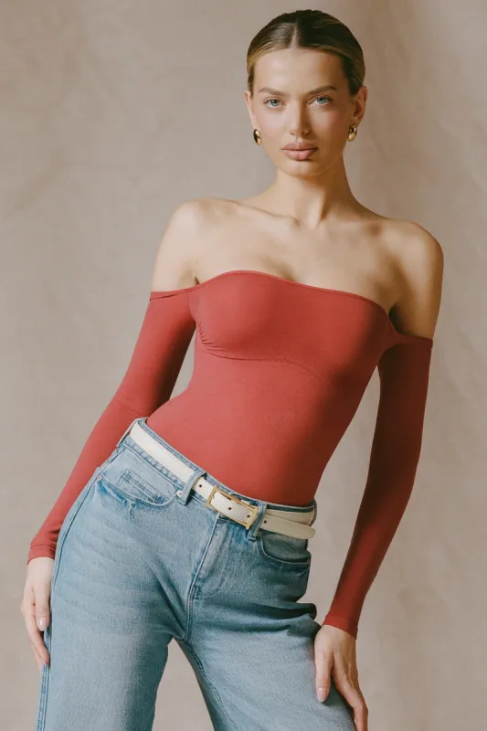 Seamless Off-Shoulder Long-Sleeve Bodysuit in Brick Red sold by Oh Polly