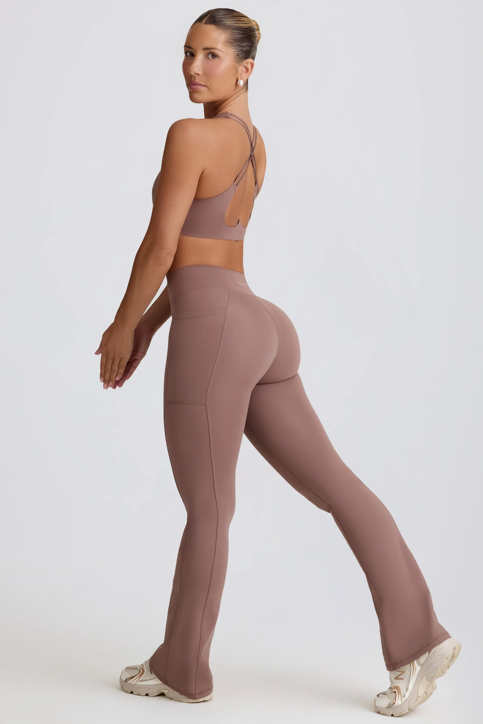 Soft Active Crossover Flared Trousers in Mocha sold by Oh Polly