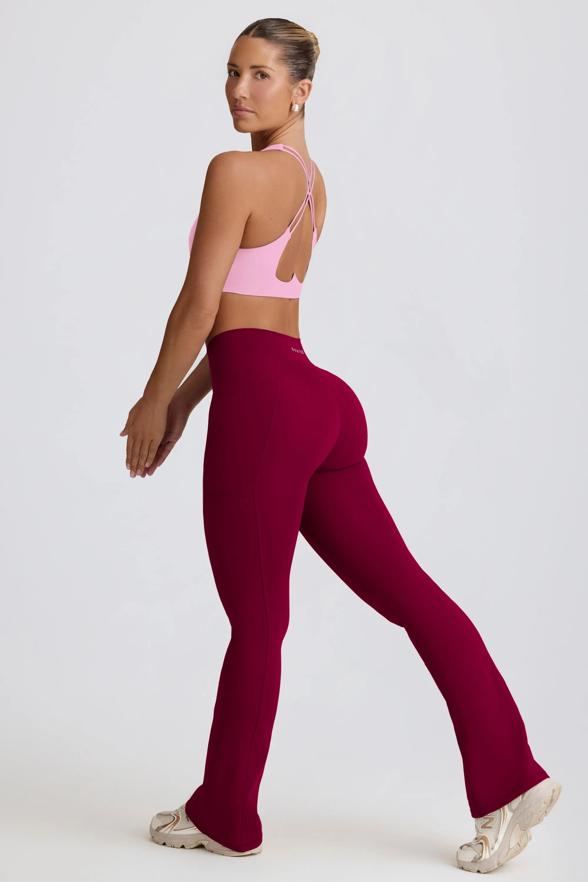 Soft Active Crossover Flared Trousers in Burgundy sold by Oh Polly