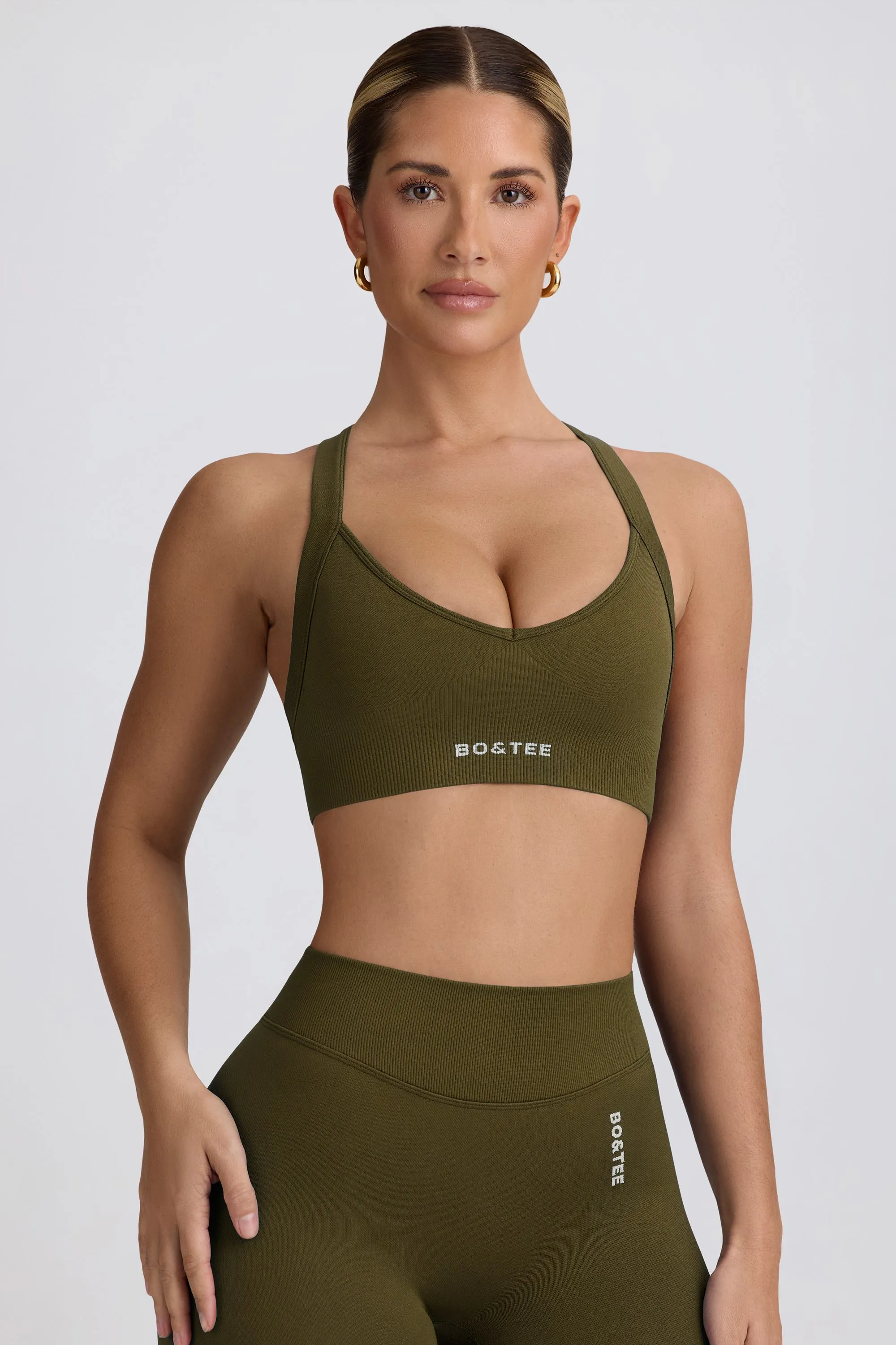 Super Sculpt Seamless Cross-Back Sports Bra in Dark Green sold by Oh Polly
