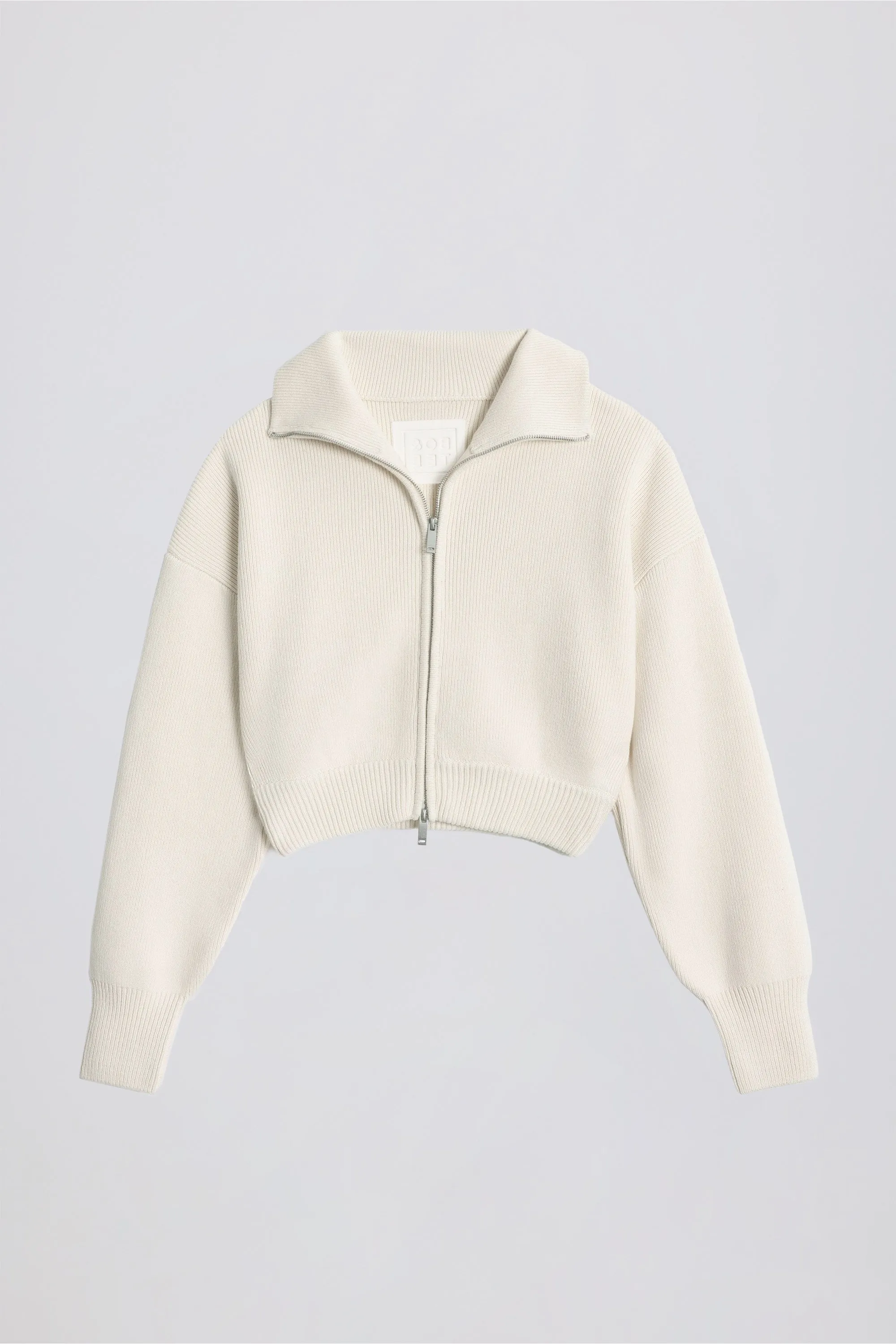 Ribbed Knit Zip-Up Cropped Sweatshirt in Ivory sold by Oh Polly