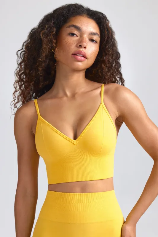 Define Luxe V-Neck Sports Bra in Golden Yellow sold by Oh Polly