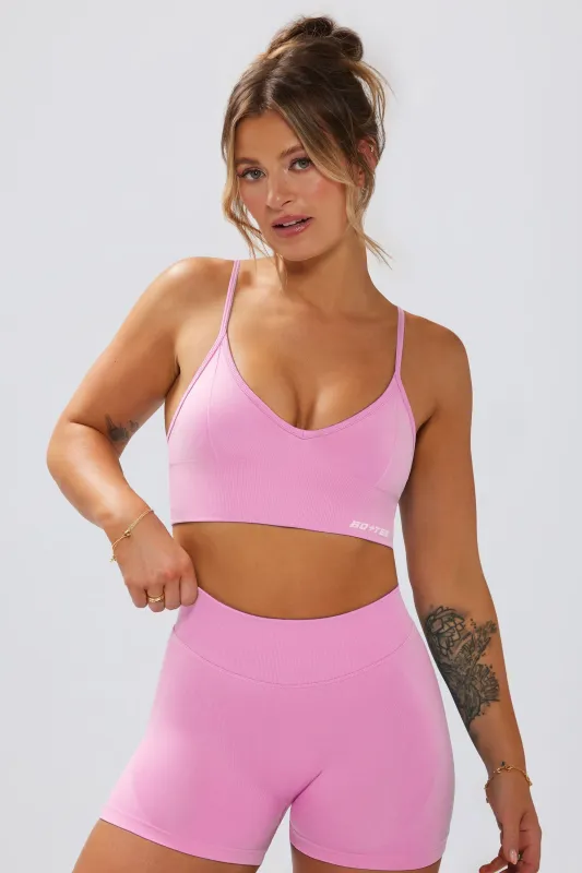 Define Luxe V-Neck Sports Bra in Bubblegum Pink sold by Oh Polly
