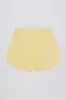 Button-Detail Mid-Rise Shorts in Lemon sold by Oh Polly