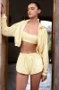 Button-Detail Mid-Rise Shorts in Lemon sold by Oh Polly