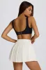 Soft Active Crossover Pleated Mini Skort in Ivory sold by Oh Polly