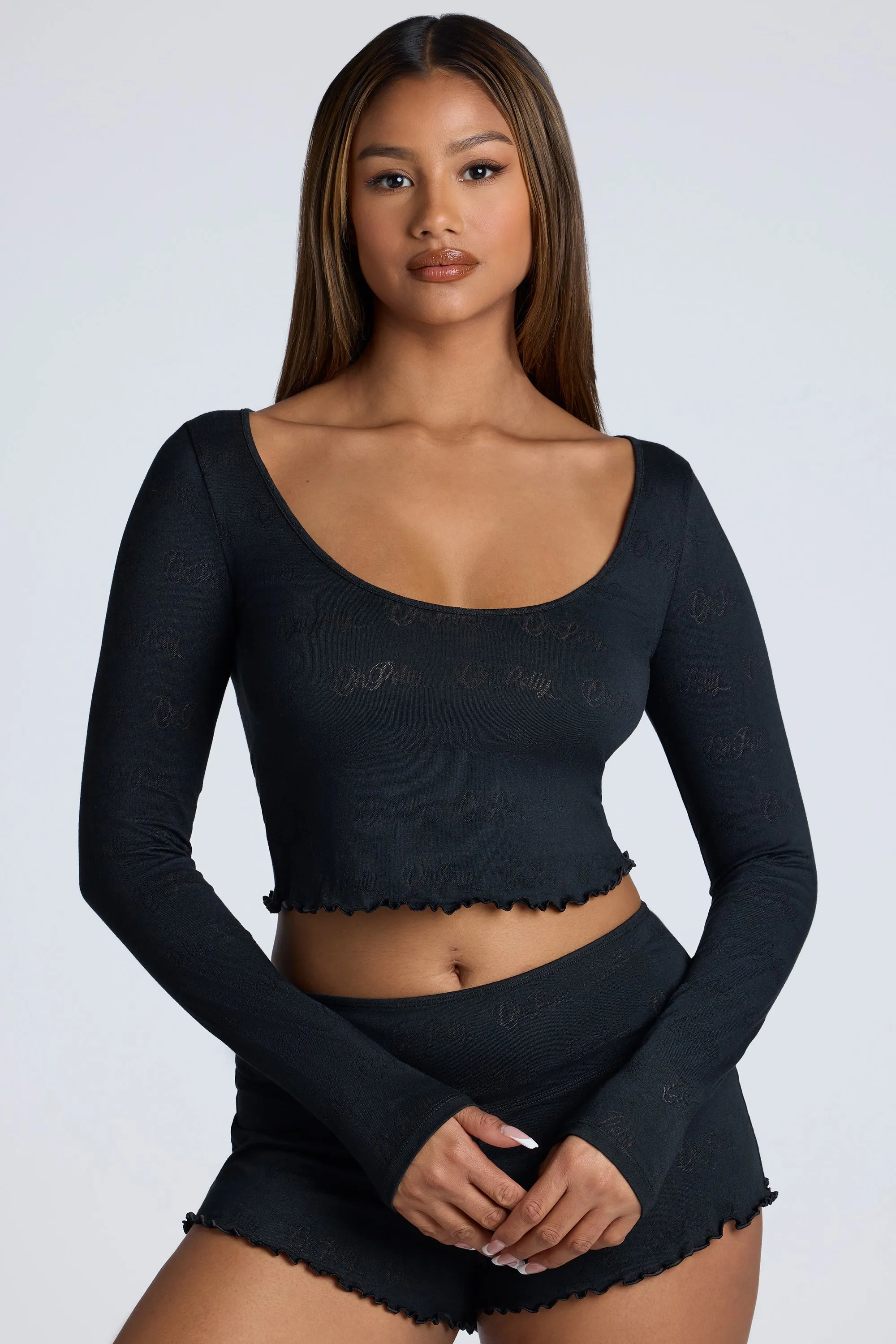 Long Sleeve Scoop Neck Pointelle Crop Top in Black sold by Oh Polly