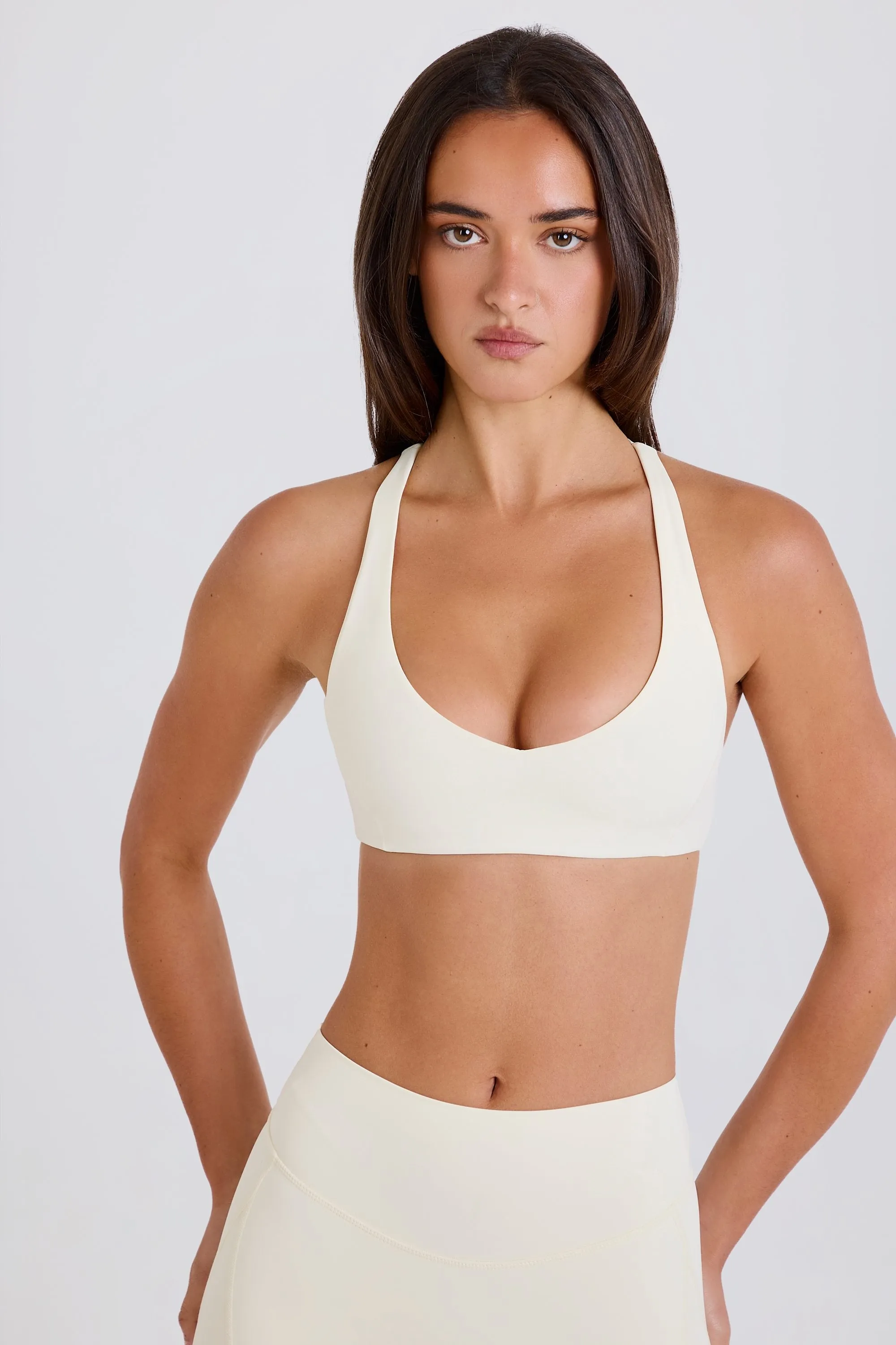 Crossback V-Neck Sports Bra in Cream sold by Oh Polly