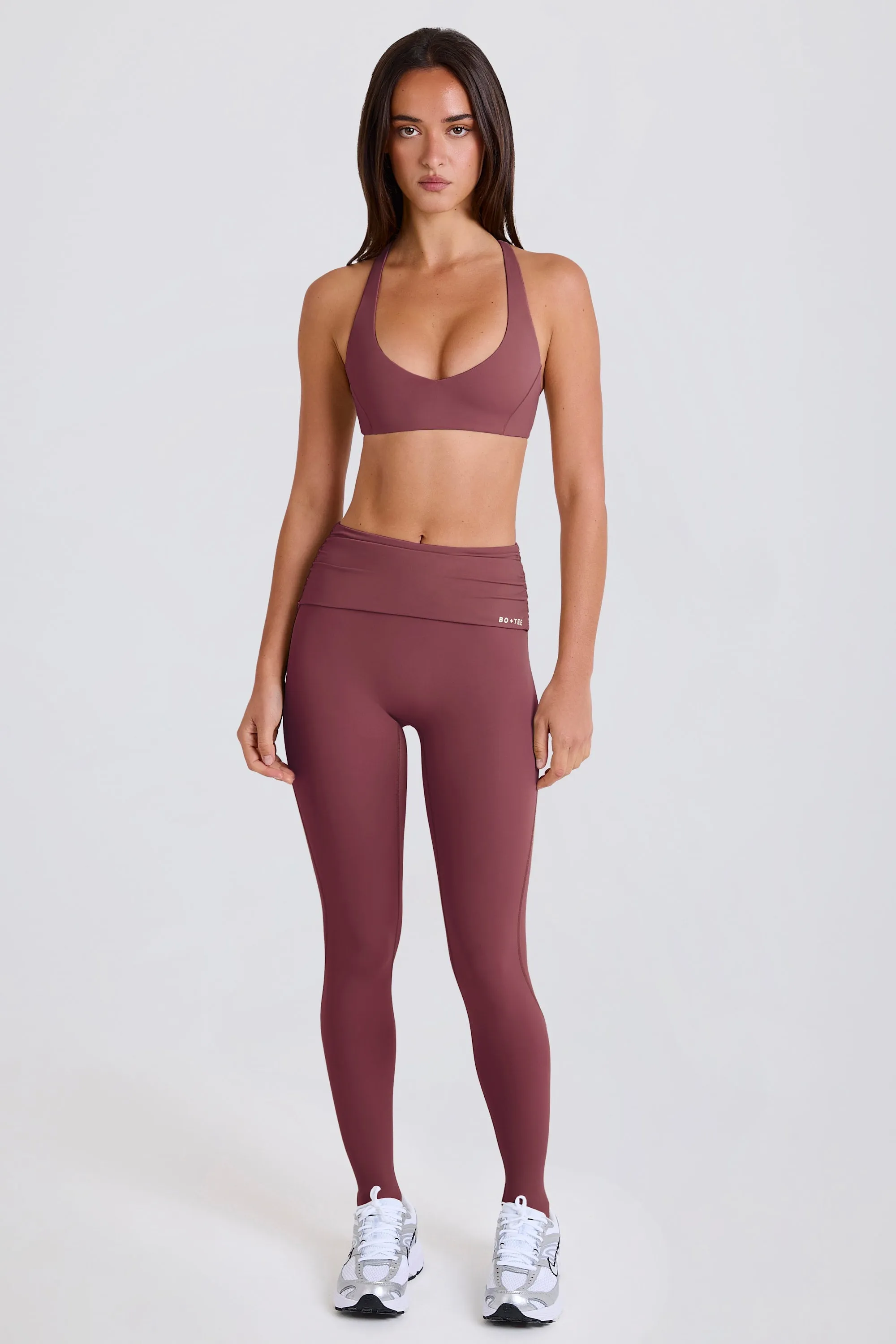 Four-Way Stretch Foldover Mid-Rise Stirrup Leggings in Acai sold by Oh Polly