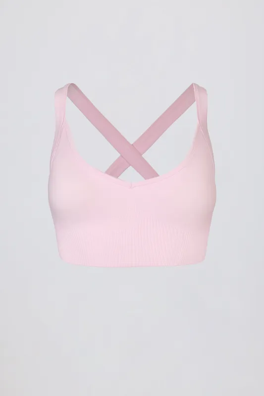 Super Sculpt Seamless Cross-Back Sports Bra in Powder Pink sold by Oh Polly