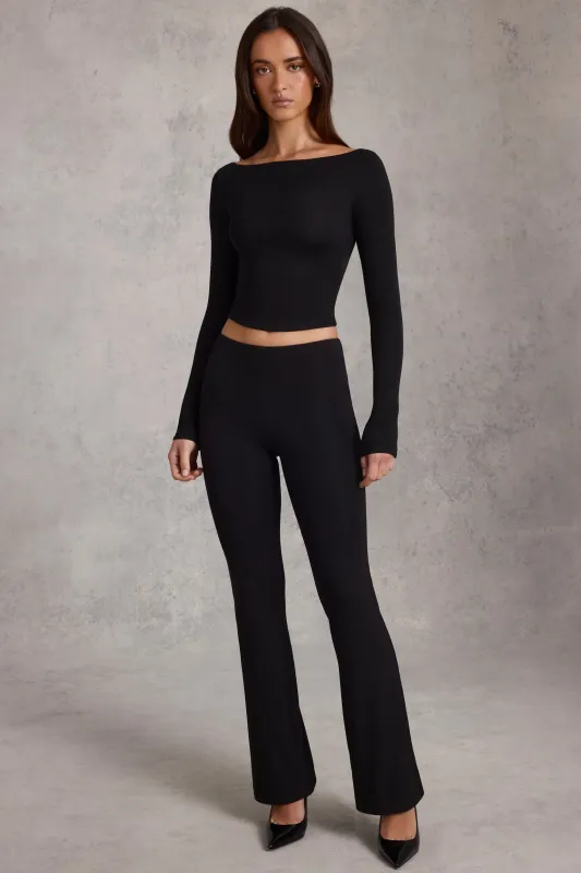 Modal Mid-Rise Flared Trousers in Black sold by Oh Polly