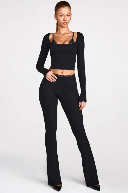 Modal Mid-Rise Flared Trousers in Black sold by Oh Polly