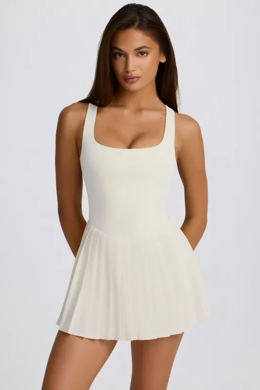 Soft Active Open-Back Pleated Tennis Dress in Marshmallow made by Bo + Tee