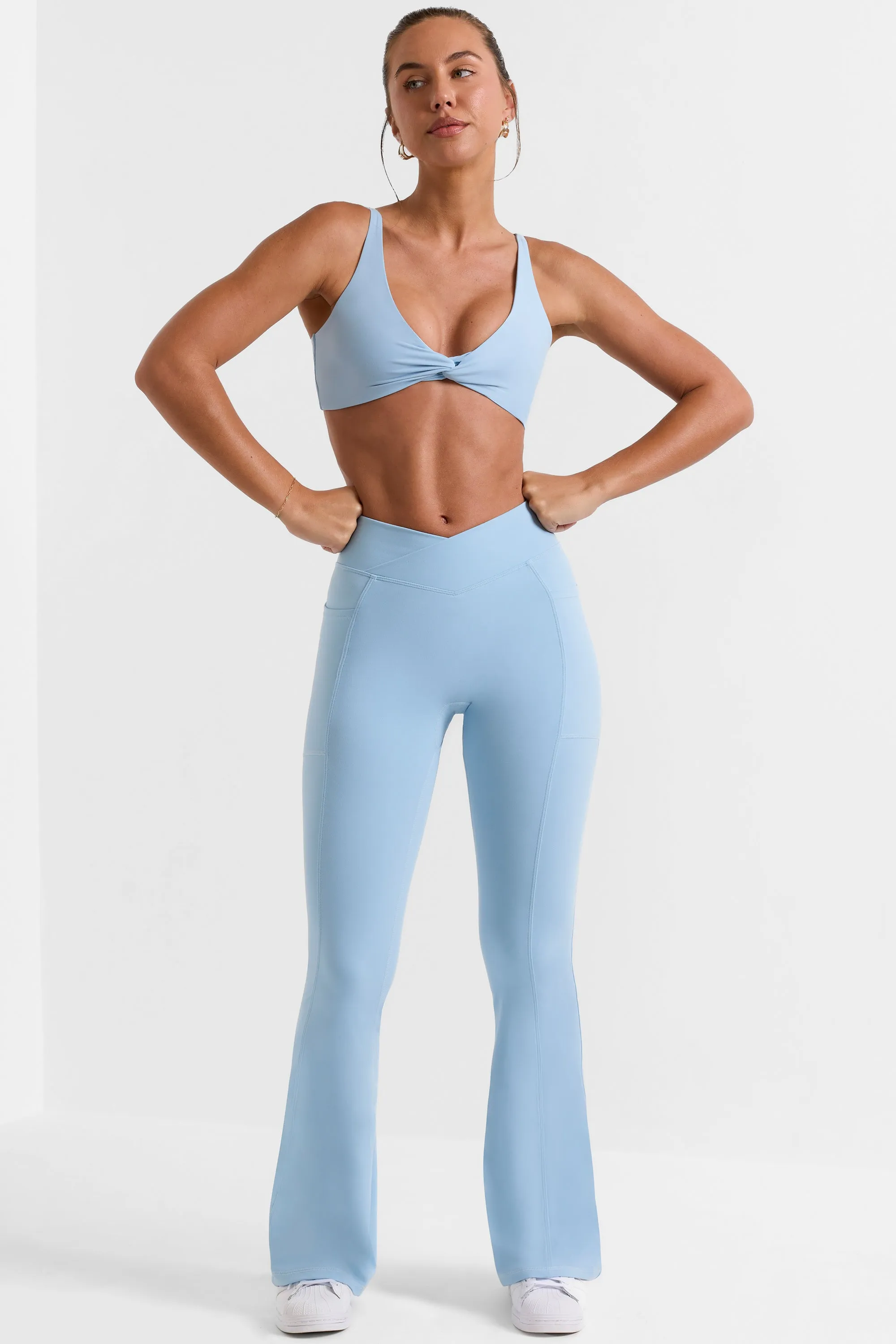 Cross Waistband Flare Pocket Leggings in Ice Blue sold by Oh Polly