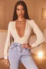Plunge Neck Long Sleeve Bodysuit in Cream sold by Oh Polly