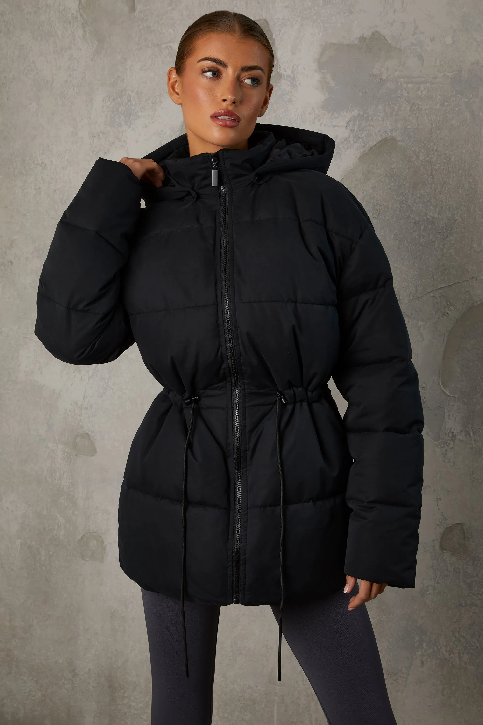 Mid Length Hooded Puffer Coat in Black sold by Oh Polly