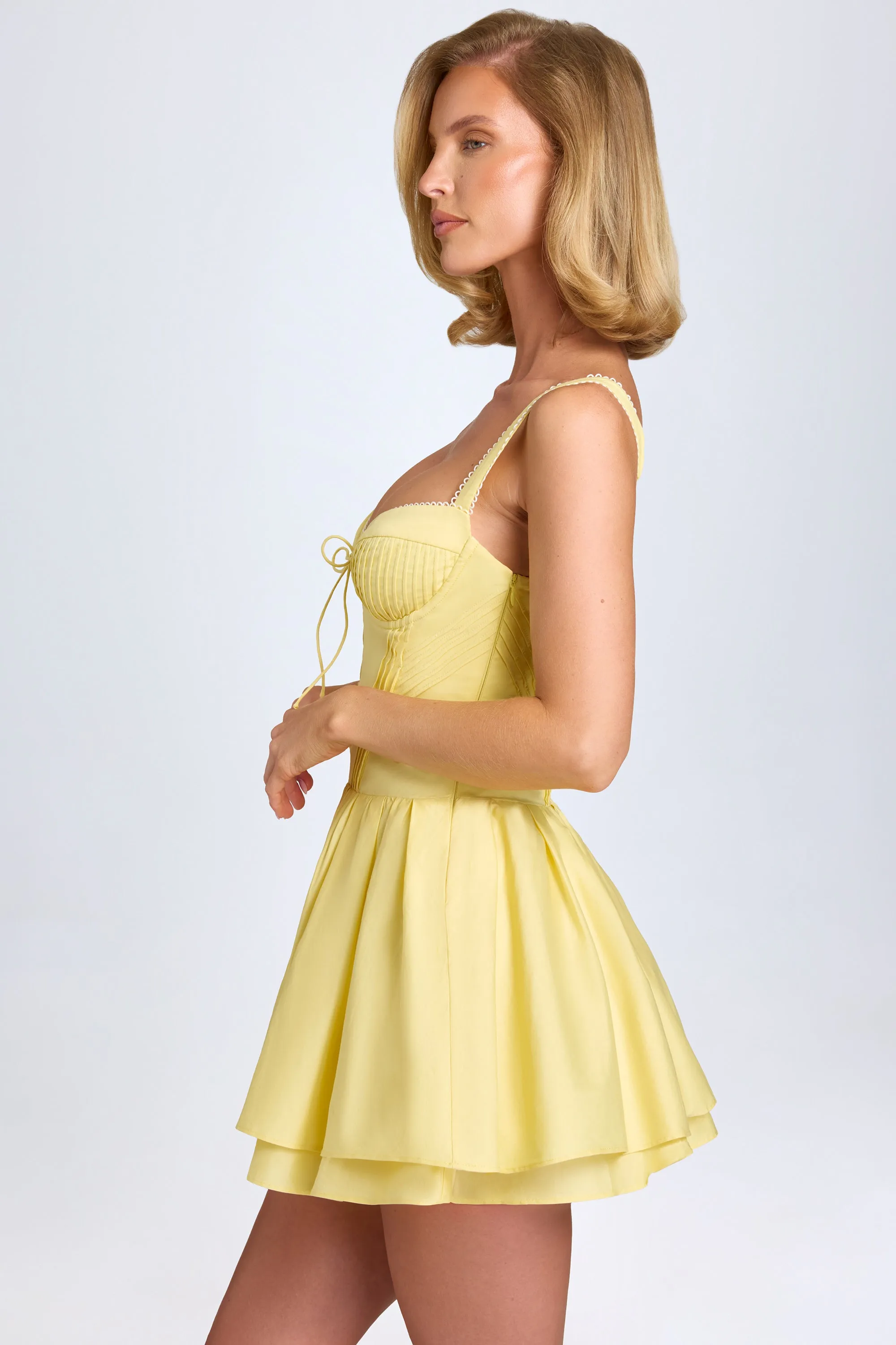 Pintucked Lace-Up Corset Mini Dress in Pastel Yellow sold by Oh Polly product image thumbnail 4