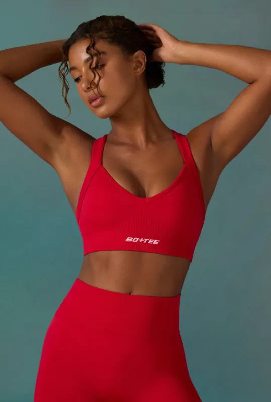Super Sculpt Seamless Cross Back Sports Bra in Tango Red sold by Oh Polly