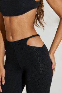 Petite Twist Strap Cut Out Flare Trousers in Black sold by Oh Polly