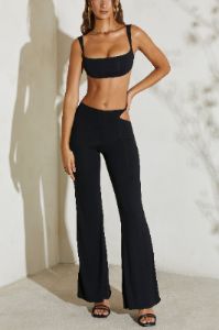 Petite Twist Strap Cut Out Flare Trousers in Black sold by Oh Polly