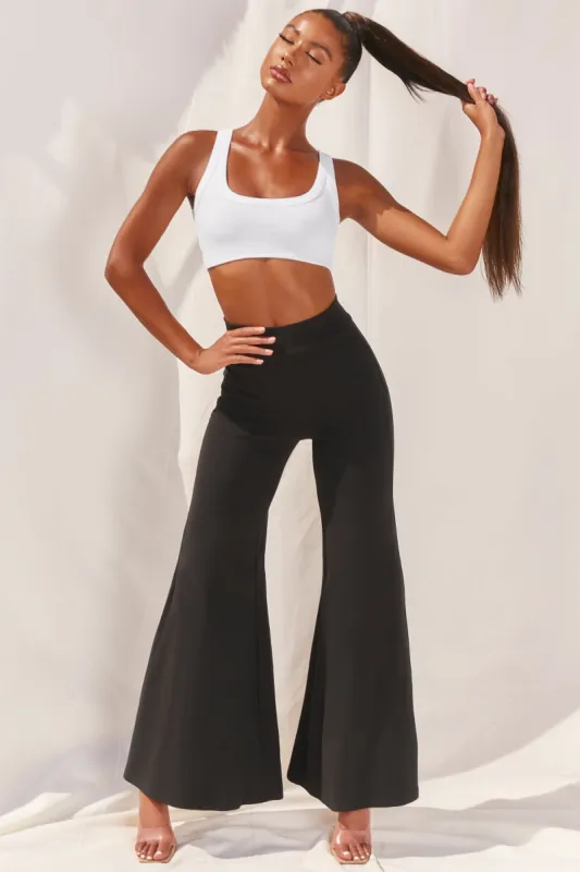 Cutting A Fine Figure Flared Trousers in Black sold by Oh Polly