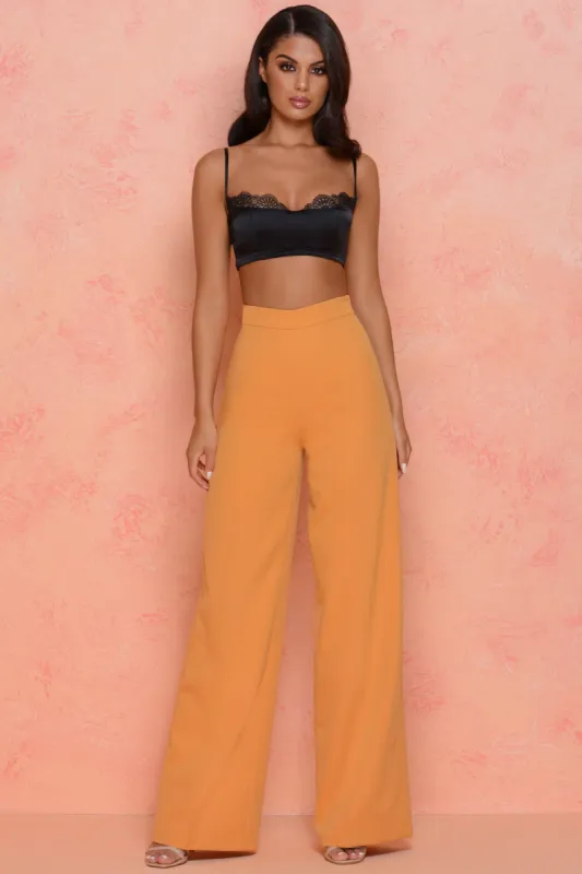 Thrill Wide High Waisted Flared Wide Leg Trousers in Orange sold by Oh Polly