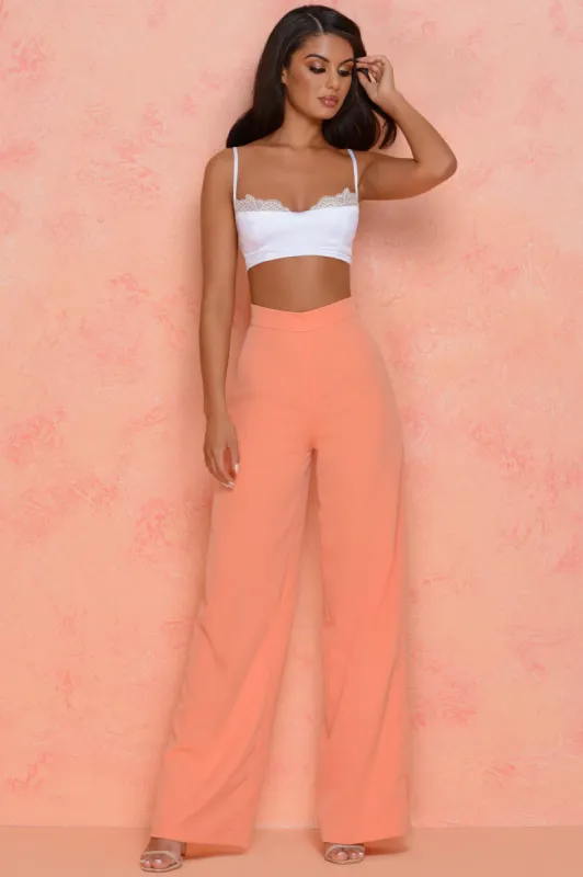 Thrill Wide High Waisted Flared Wide Leg Trousers in Peach sold by Oh Polly