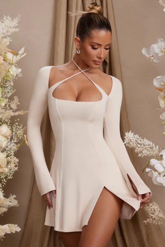 Long Sleeve Cross Over Strap Mini Dress in Cream sold by Oh Polly