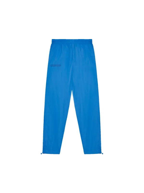Recycled Nylon Track Pants—cerulean blue sold by Pangaia