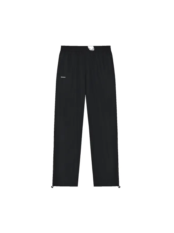 Mens DNA Recycled Nylon Track Pants—black sold by Pangaia
