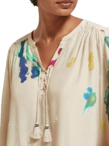 Lace-up blouse with balloon sleeves sold by Pepin