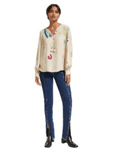 Lace-up blouse with balloon sleeves sold by Pepin