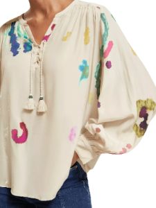 Lace-up blouse with balloon sleeves sold by Pepin