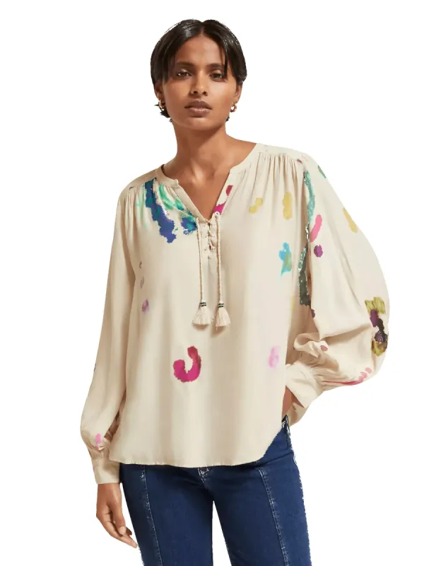 Lace-up blouse with balloon sleeves sold by Pepin